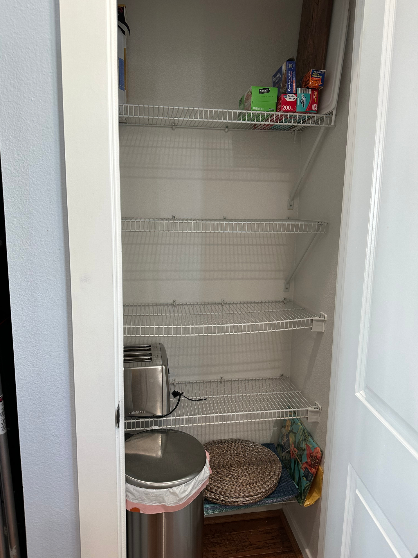 Condo pantry closet with appliances and supplies