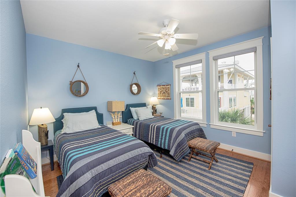 Back bedroom with two twin beds and large windows